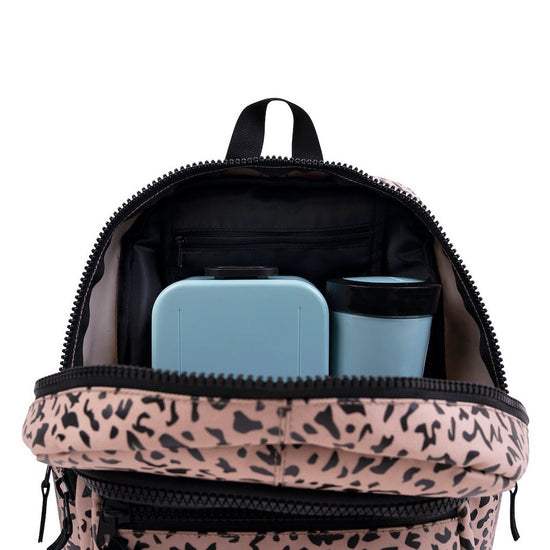 This picture shows a kids backpack in dessert shark print. Made from recycled plastic. Adjustable comfort straps. Front pocket with zip. A padded compartment inside and pockets for a lunchbox and water bottle. 