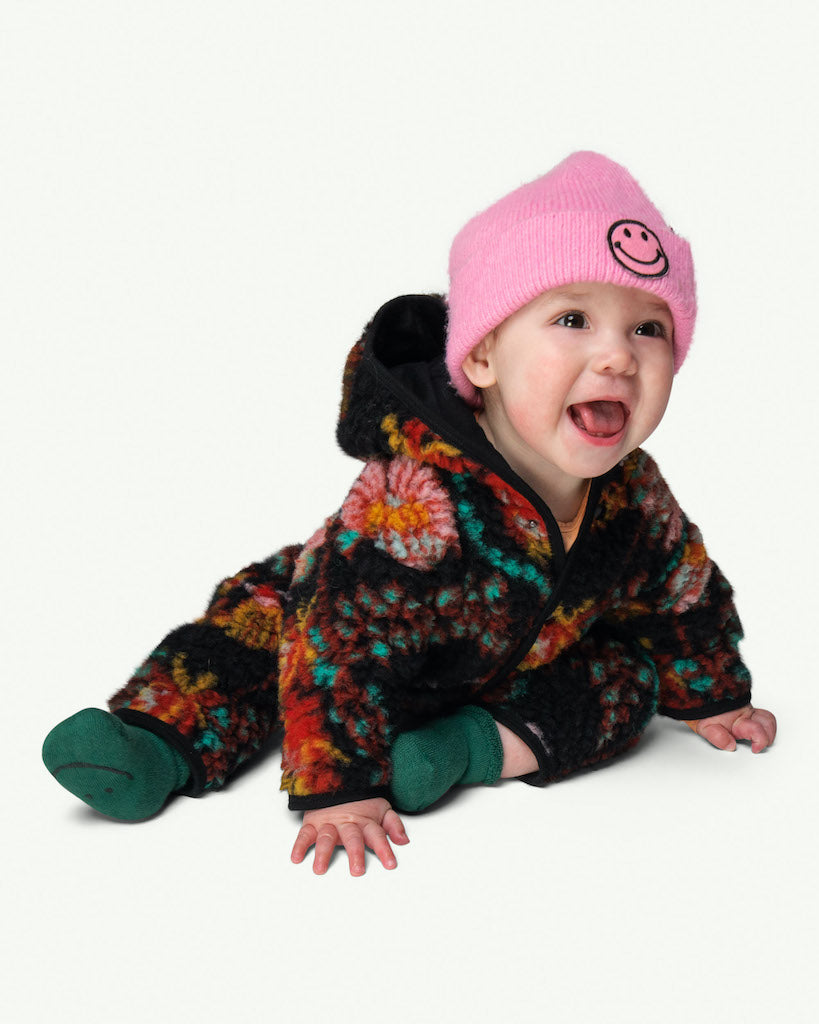 This picture shows a baby wearing Green organic cotton baby socks with an anti slip smily print at the bottom.