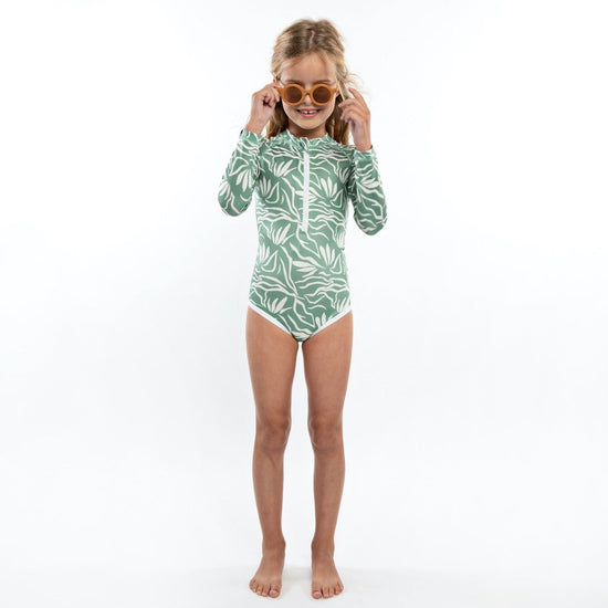 This picture shows a longsleeve girls swimsuit in a basil green with tropical print. UPF50 Available up to size 6