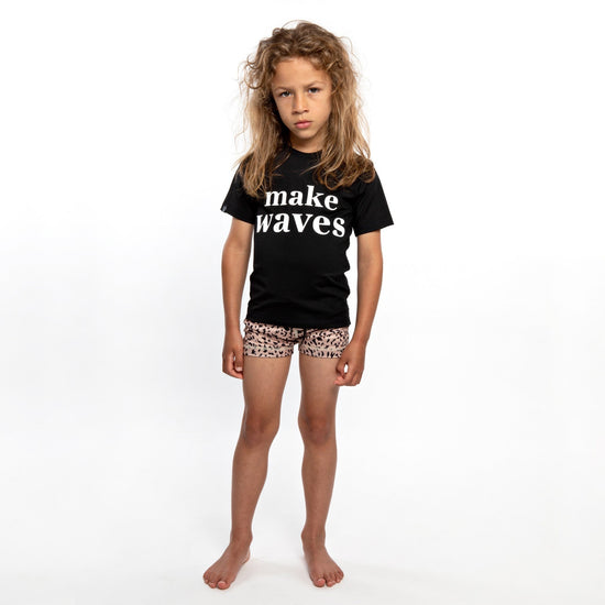 Load image into Gallery viewer, This picture shows a boy wearing the make waves print, UPF50+ short sleeve rashie
