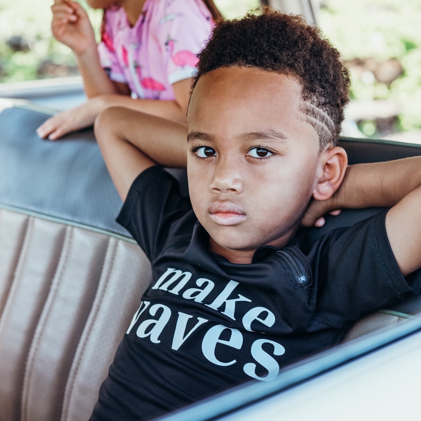 This picture shows a boy wearing the make waves print, UPF50+ short sleeve rashie