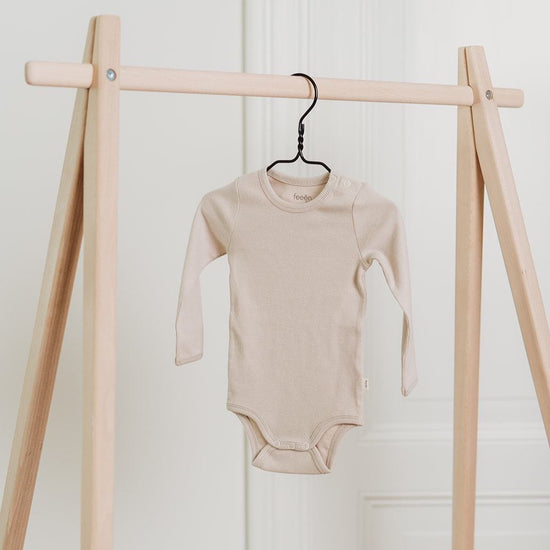 organic cotton longsleeve bodysuit, onesie for babies and toddlers. neutral almond colour. With snaps at shoulder and crotch for easy changning