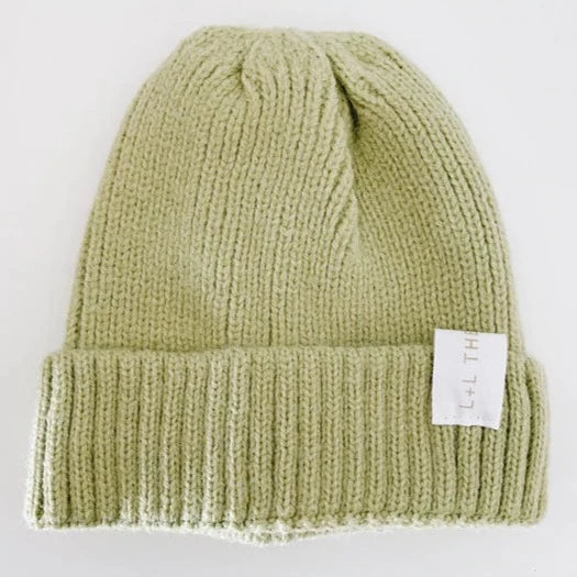 This picture shows a and warm soft knit kids winter hat in a cool lime green colour. from 6 months to 6 years