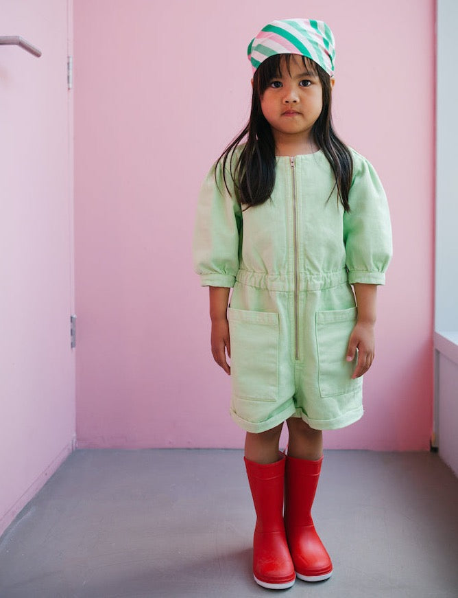 Load image into Gallery viewer, This picture shows a girl wearing a comfy jumpsuit in lime green. With puffy mid-length sleeves and a zip closure at the front.
