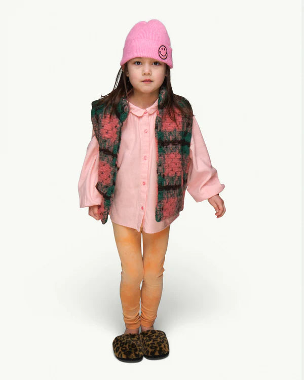 This picture shows a child wearing the soft knitted pink beanie with a funny smily patch