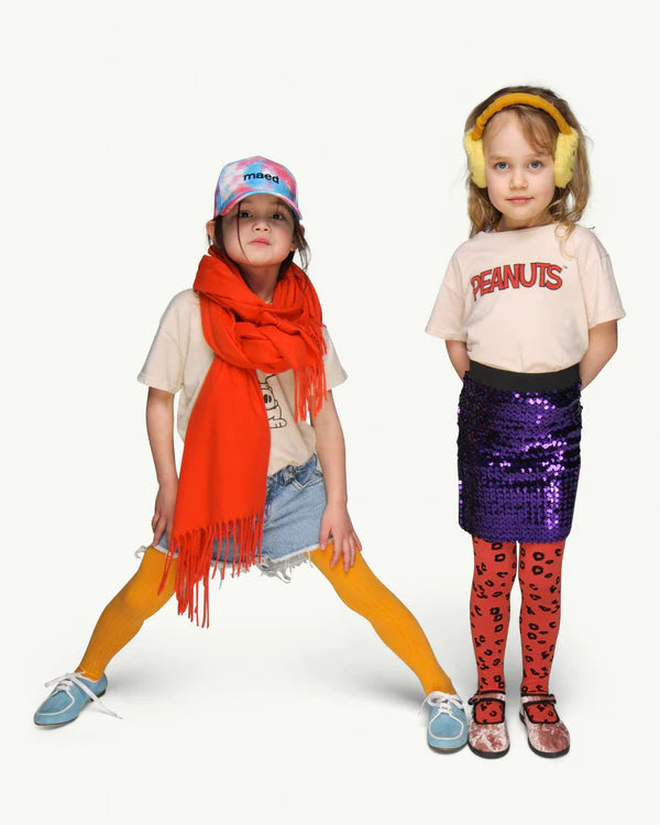 Load image into Gallery viewer, This picture shows 2 girls wearing the off white organic cotton peanuts collar tees from Maed for Mini. One has Snoopy on the front., and one has Peanuts written on the front
