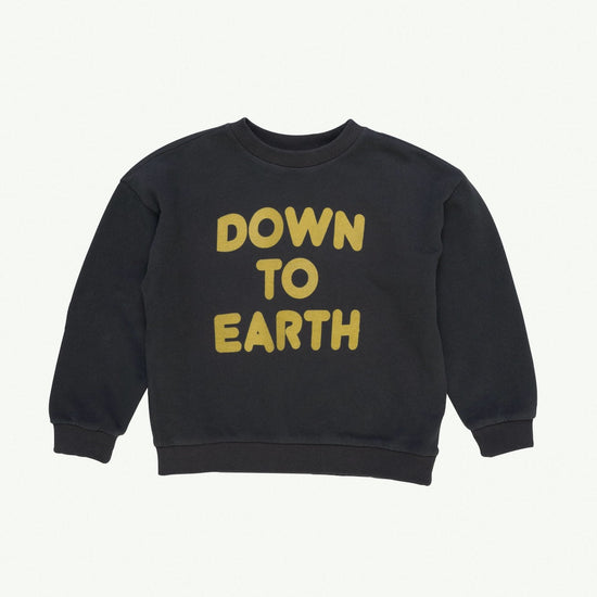 This picture shows a vintage black Sweater in a soft organic cotton fabric brushed on the inside with a bright yellow flock print text