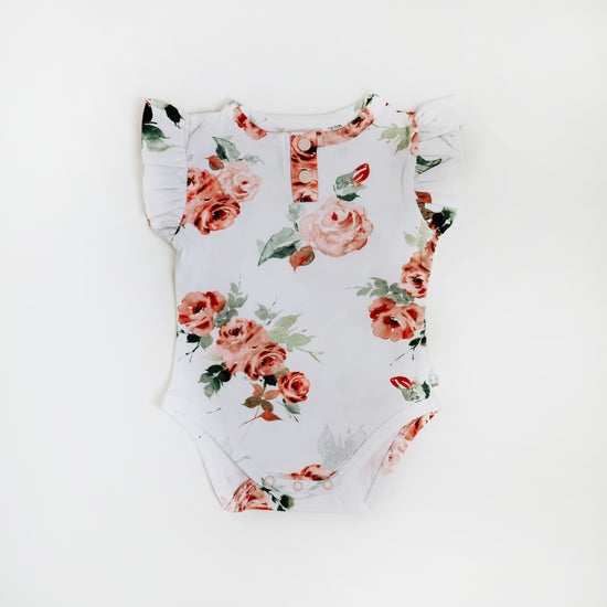 Short Sleeve Frilled Bodysuit with Rose Flowers. Snaps at the bottom for easy changing. Available from newborn till 1