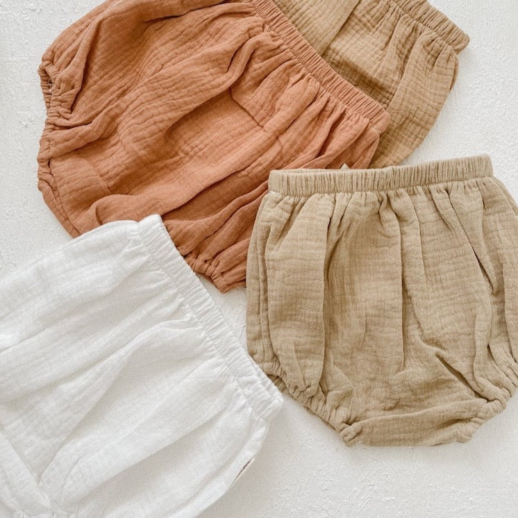 This picture shows cotton baby bloomers in a neutral stone colour 