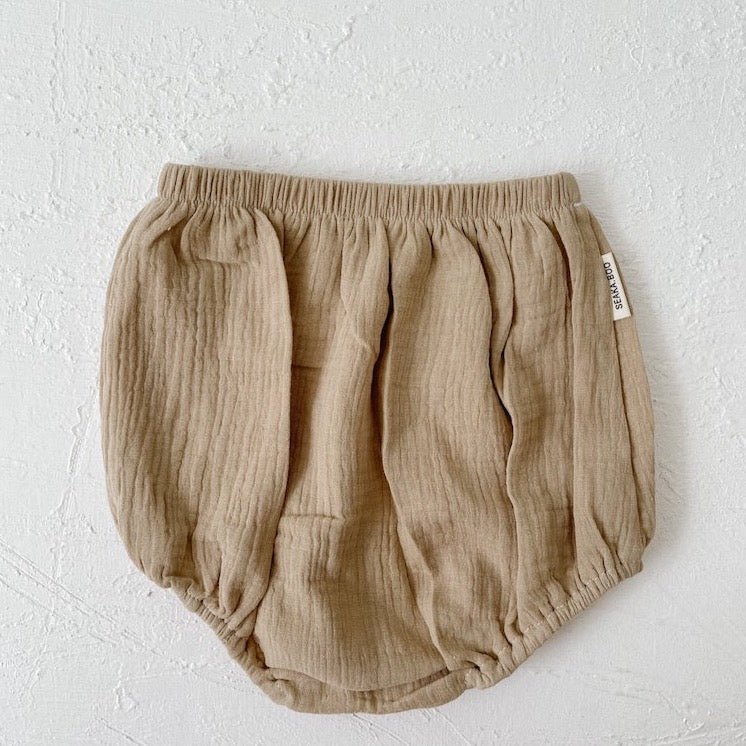 A sweet pair of organic cotton baby bloomers in a neutral stone colour