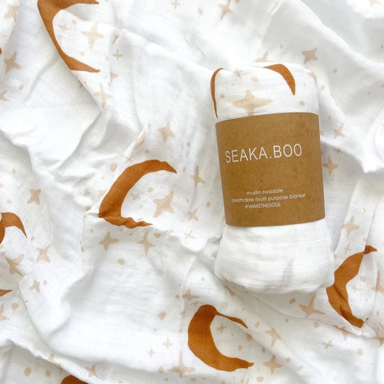 This picture shows the Bamboo/cotton Swaddle wrap with a star and moon print in Sandalwood