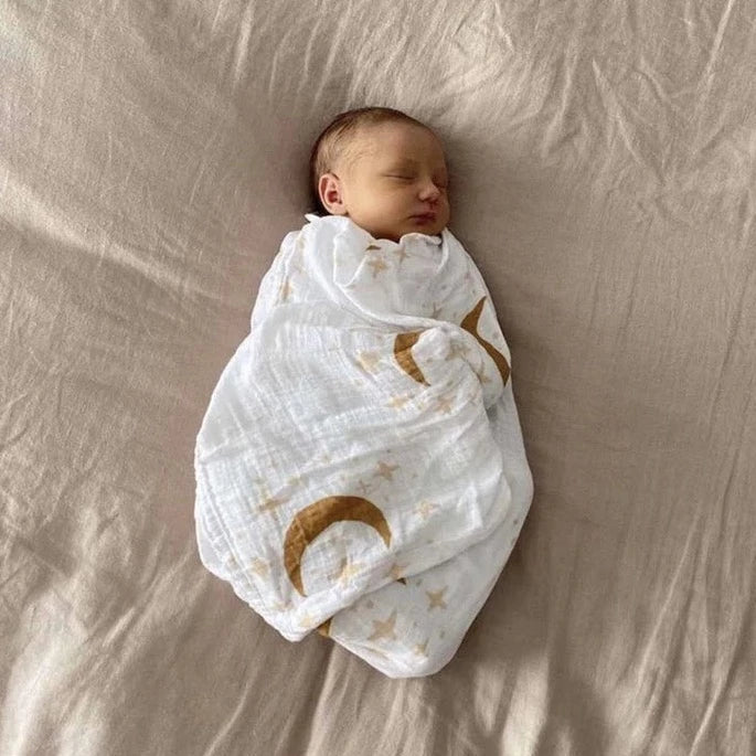 This picture shows the Bamboo/cotton Swaddle wrap with a star and moon print in Sandalwood