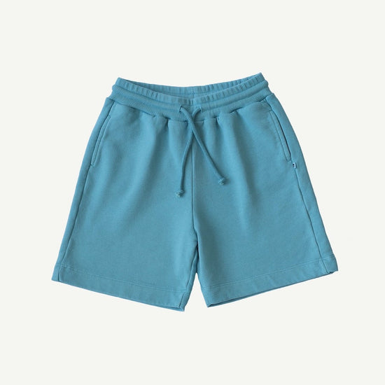 Load image into Gallery viewer, This picture shows a light blue organic cotton sweat shorts for kids. 
